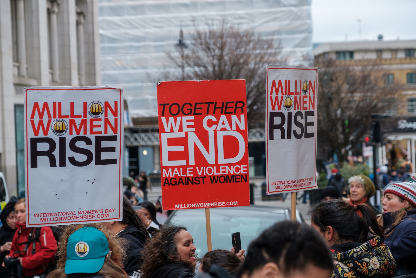 a group of people holding signs in the street